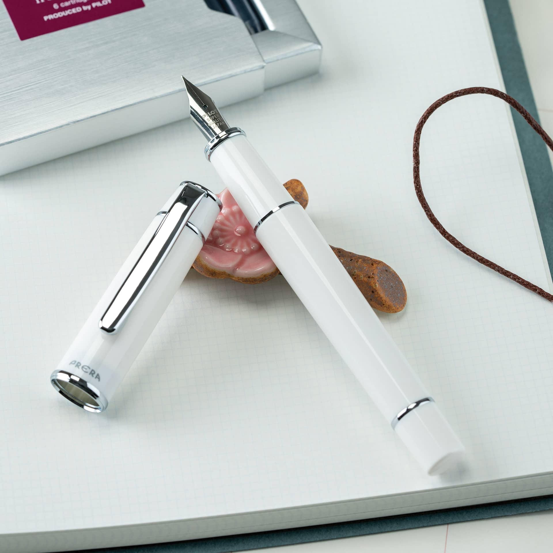 Pilot Prera Standard Fountain Pen - Porcelain White, Medium, cap off on paper pad (not included)