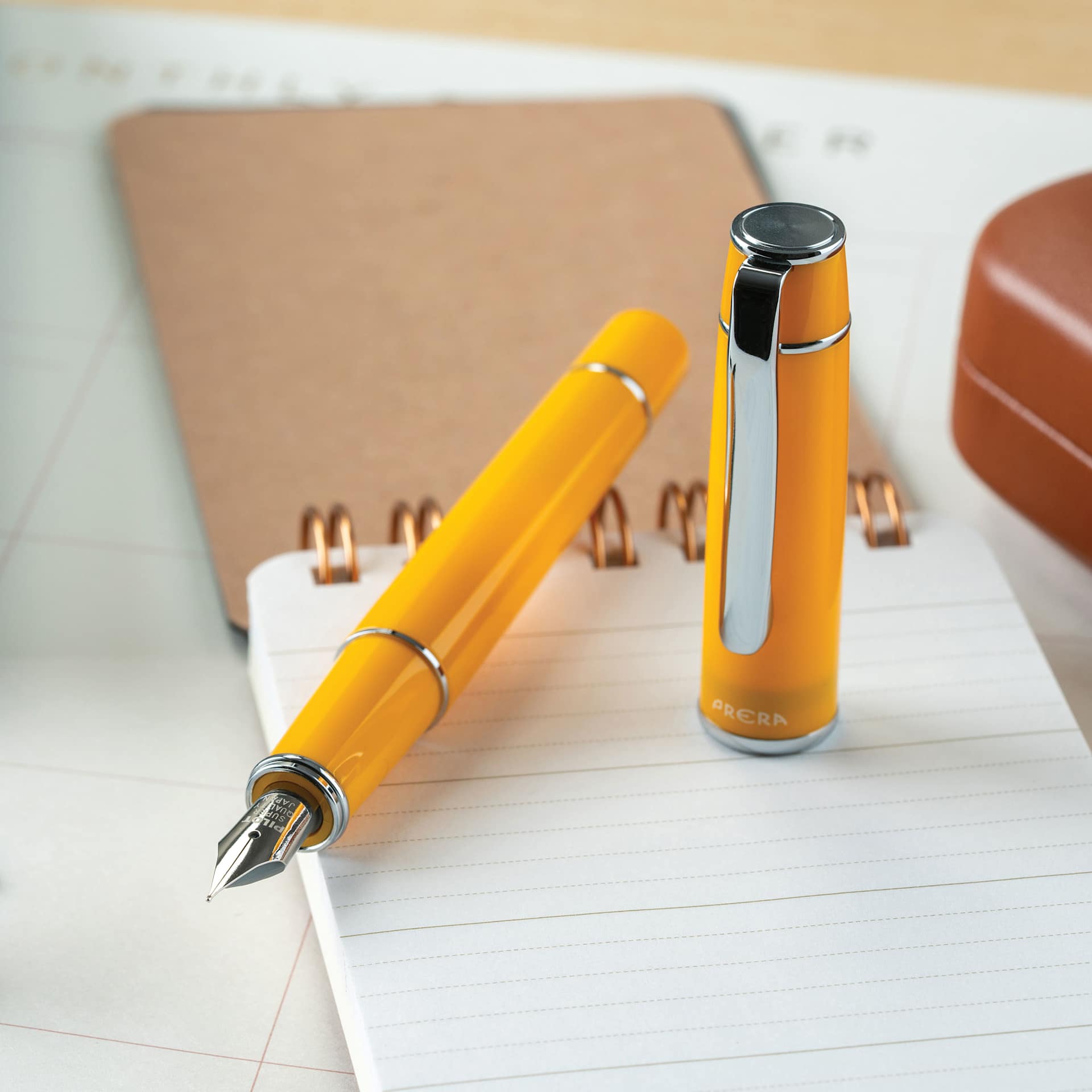 Pilot Prera Standard Fountain Pen - Honey Yellow, Medium, on notepad (not included)