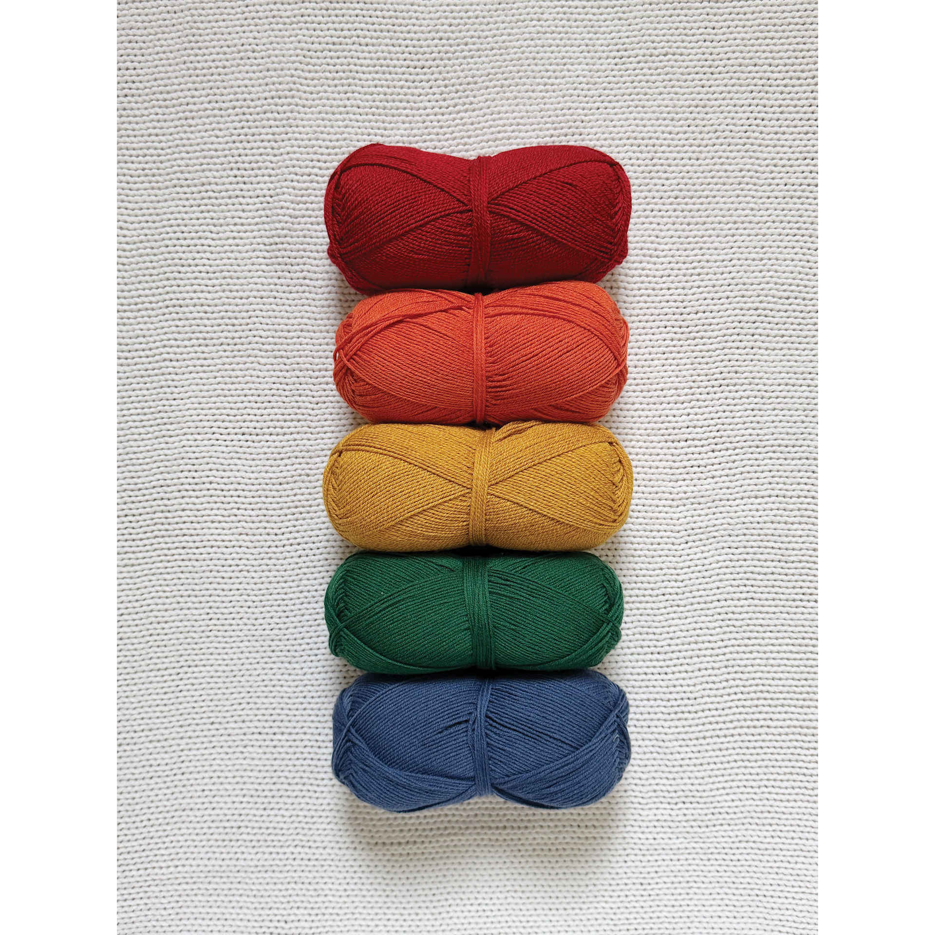 Lion Brand Cottino Yarn available colors organized together in a rainbow