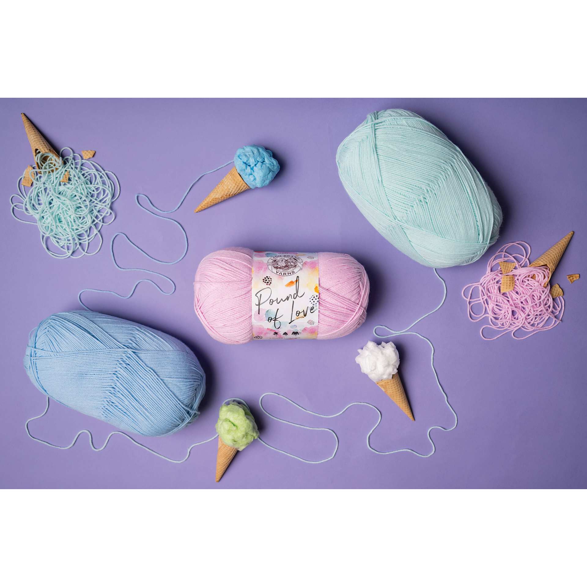 Lion Brand Pound of Love Yarn showing available color option laying beside sidewalk chalk