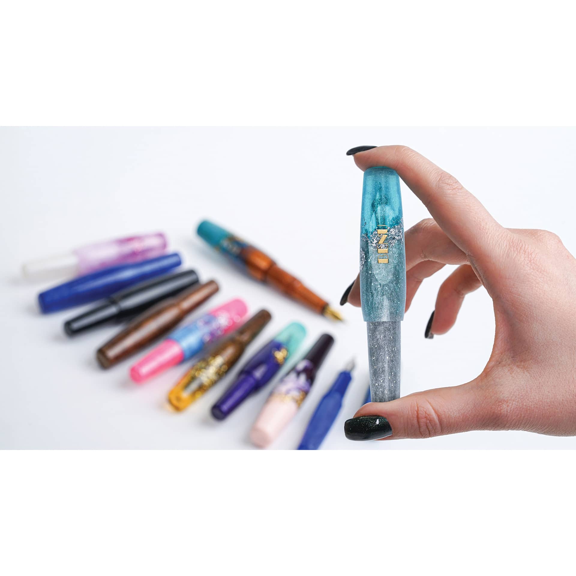 Benu Pixie Fountain Pens, one capped pen in hand