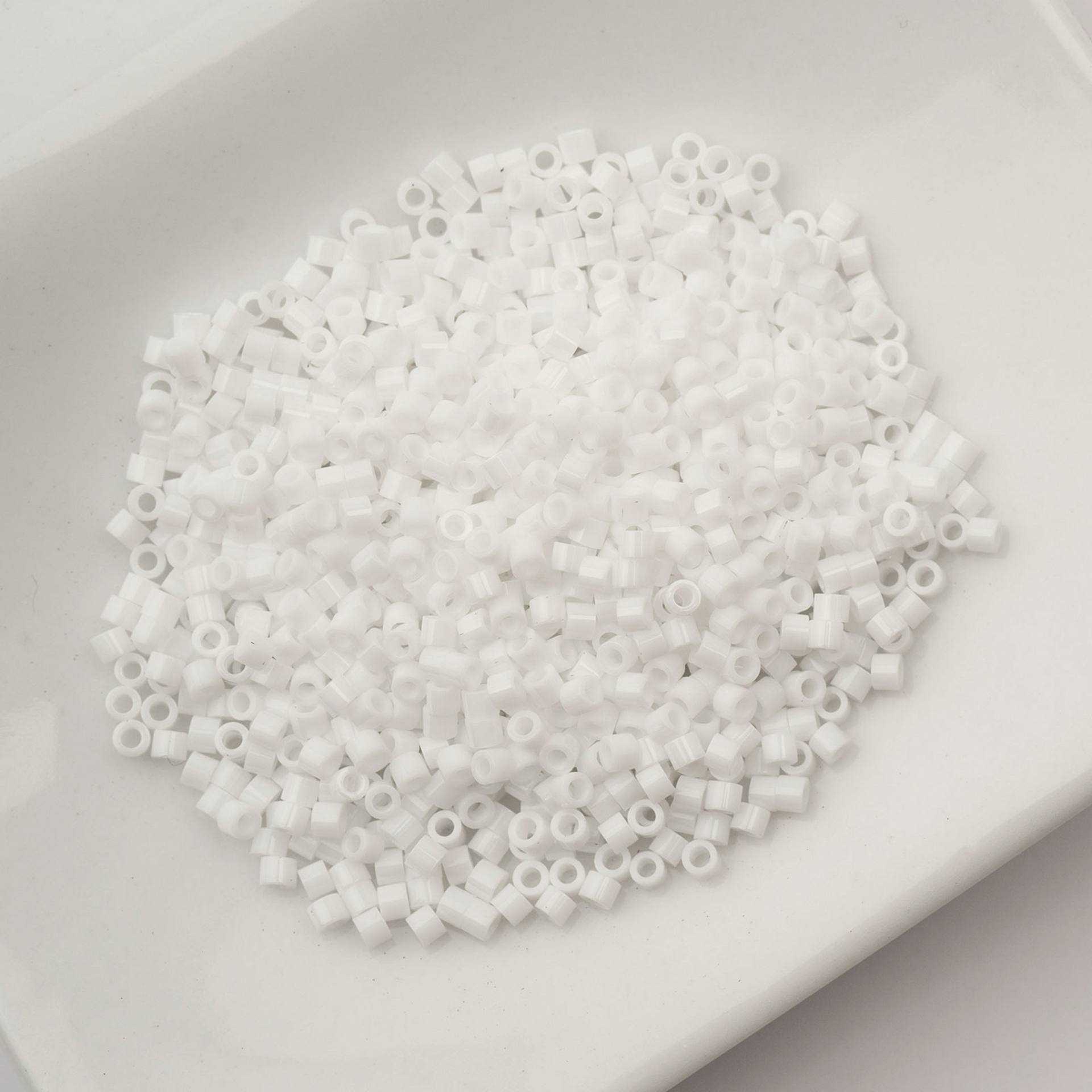 John Bead Cylin 11/0 Cylindrical Seed Beads - Chalk White sitting in dish