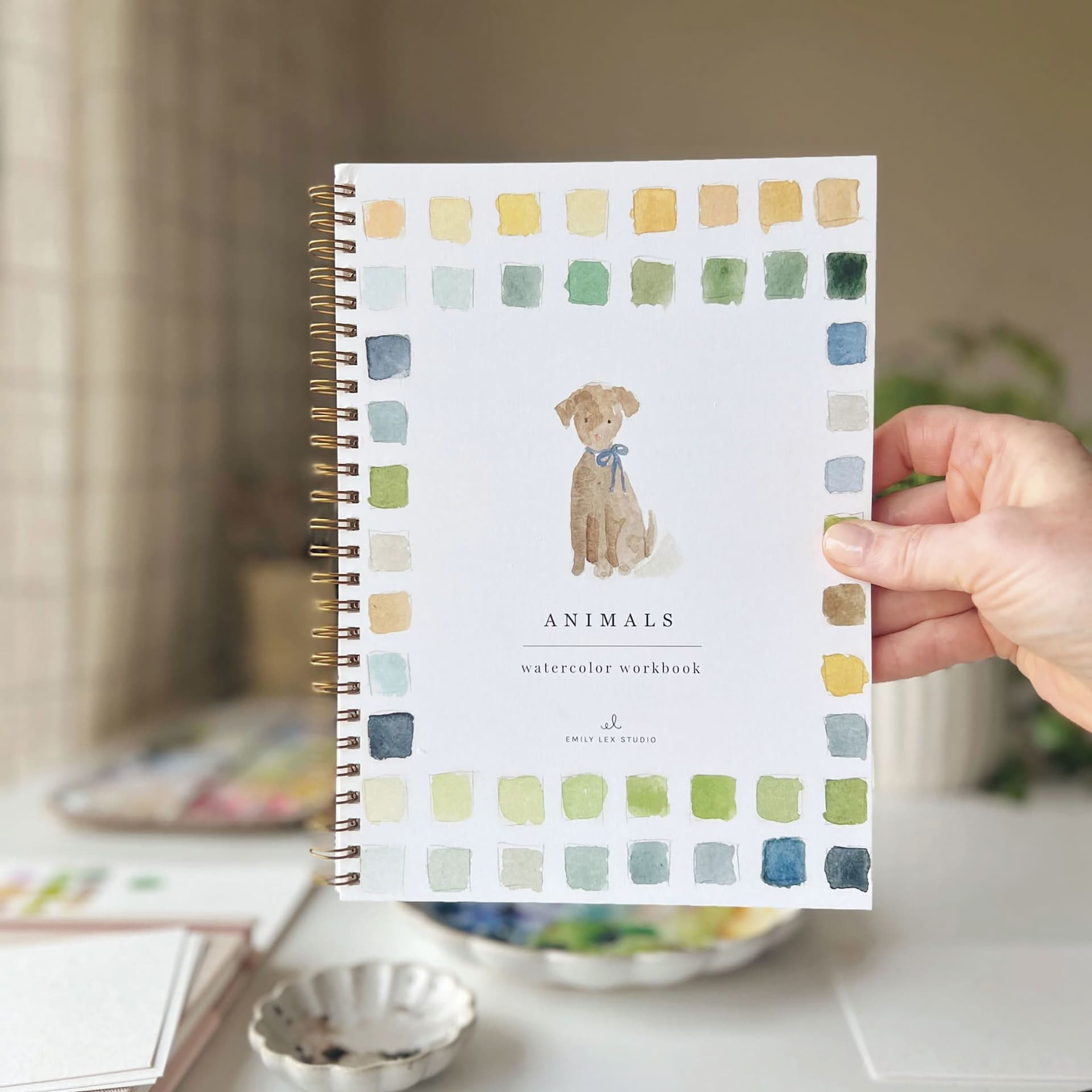Emily Lex Studio Animals Watercolor Workbook, person holding workbook