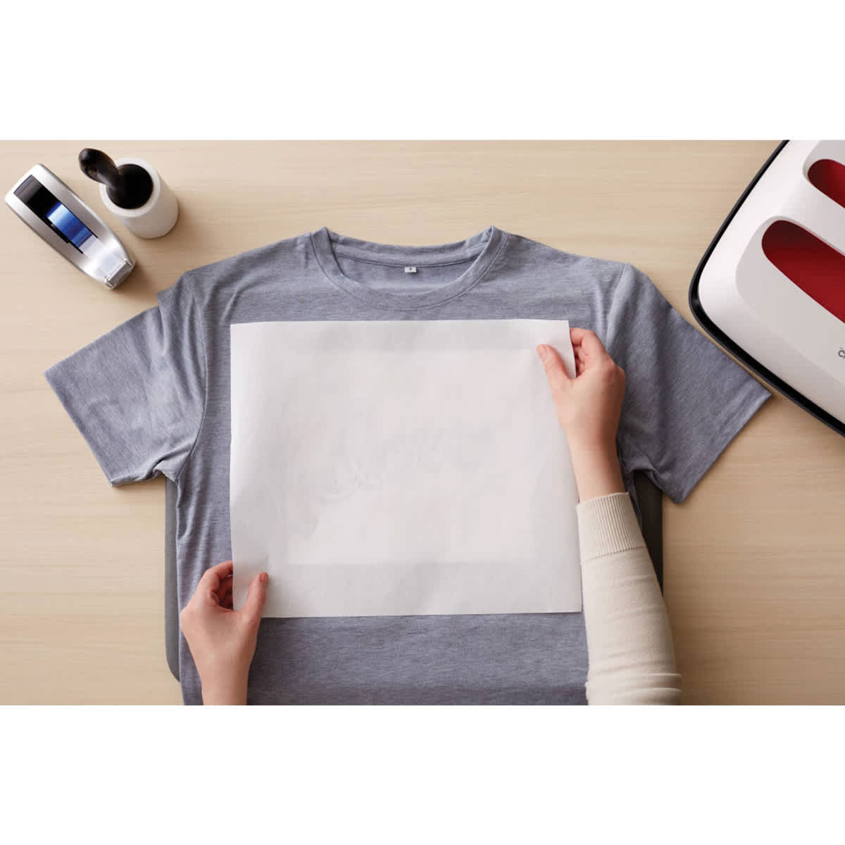 Cricut Butcher Paper - 12" x 14", 15 Sheets (Person using butcher paper over design on T-shirt)