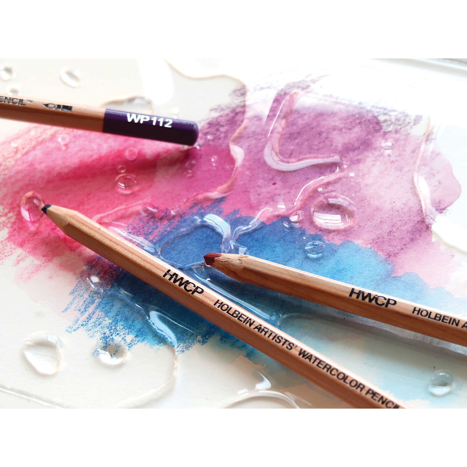 Holbein Artists' Watercolor Pencils with swatches and water
