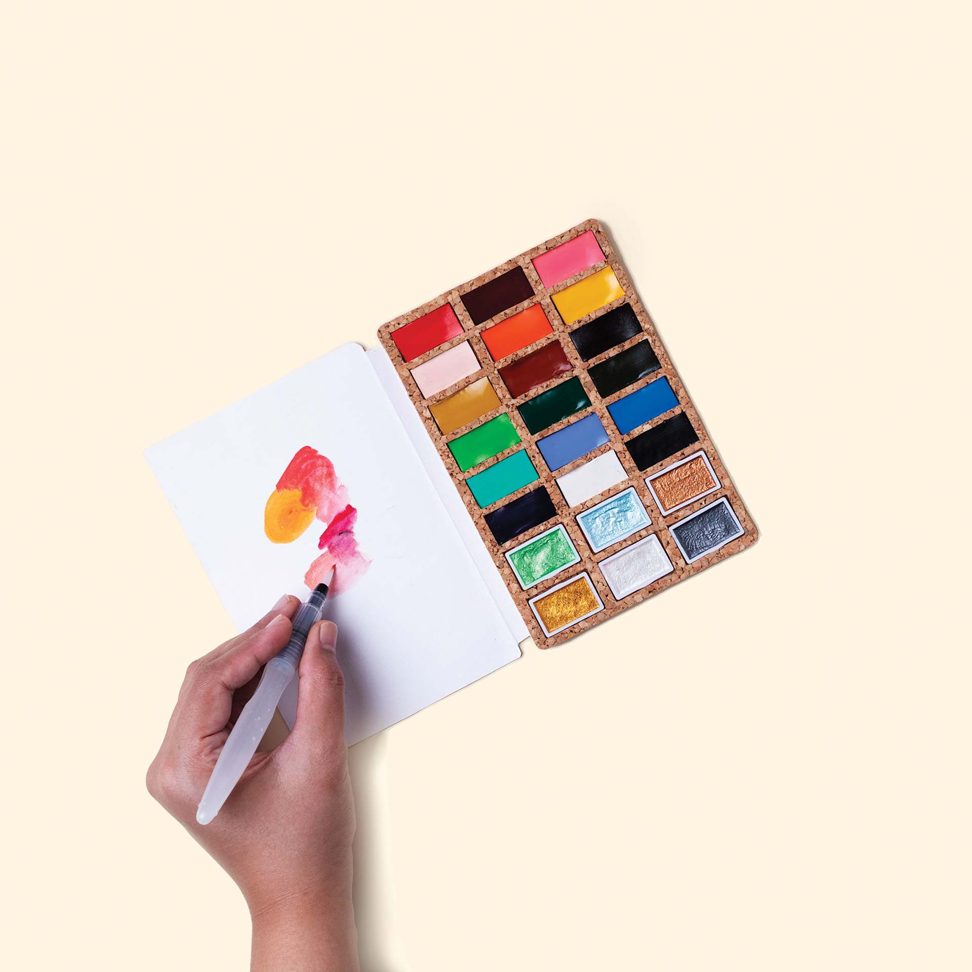 Person using the Viviva Watercolor Paint Pan Deluxe Set. Person using the Viviva Watercolor Paint Pan Deluxe Set.