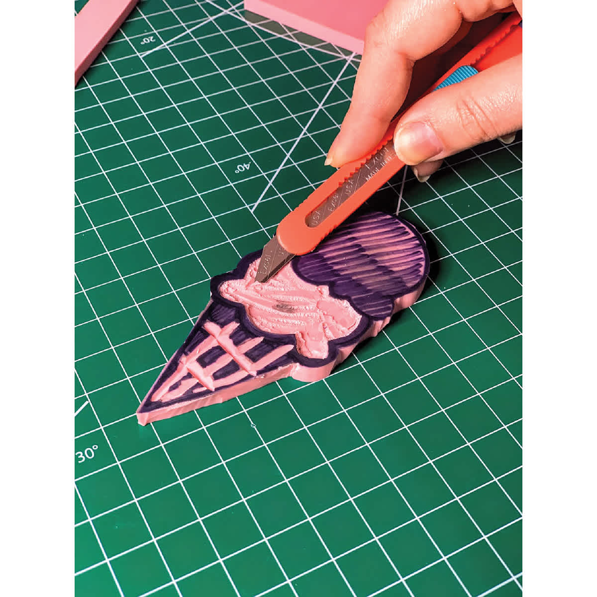 Excel Blades Smart Snap Knife - Pink Knife shown cutting on mat
