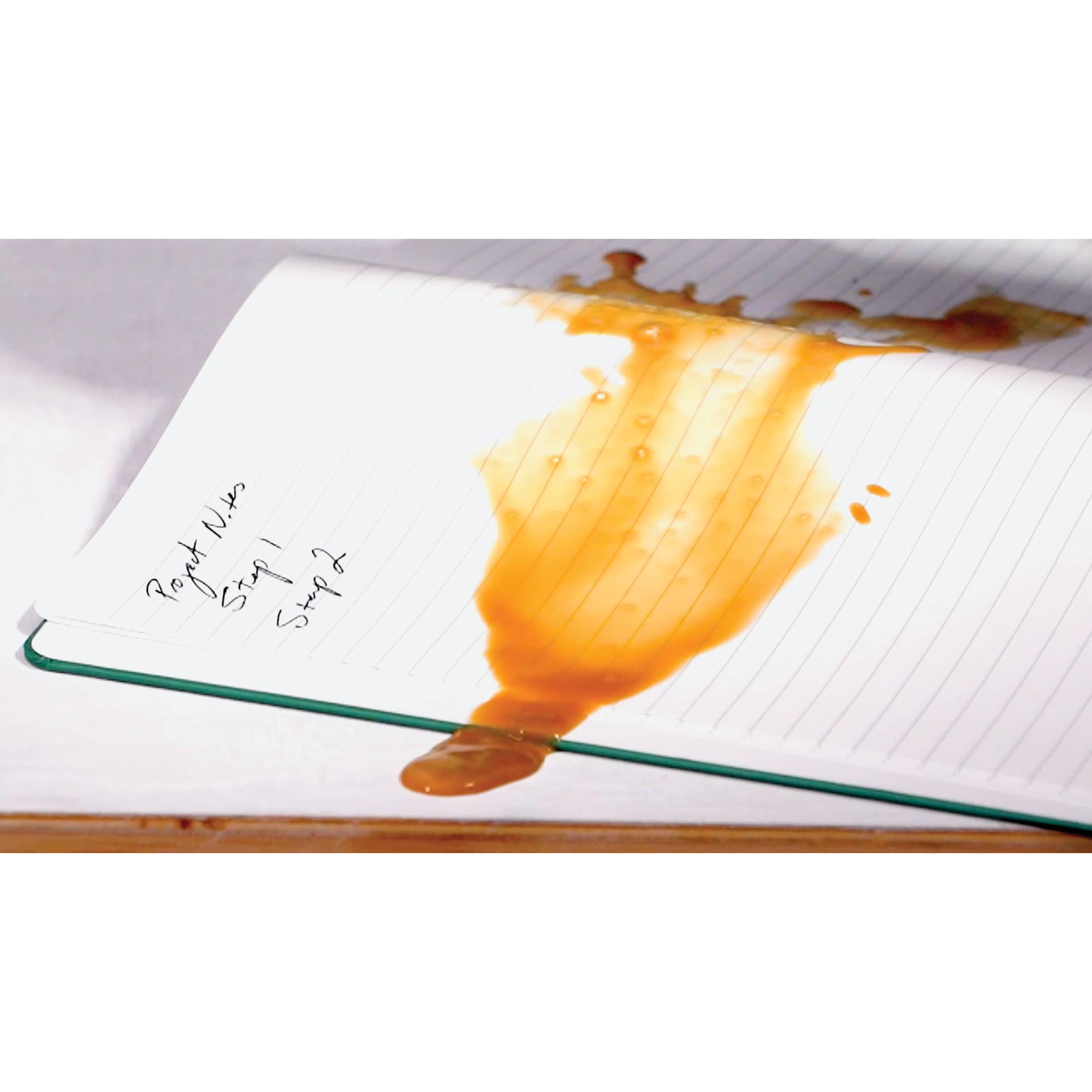 Karst Stone Paper Notebooks, coffee spilled on page