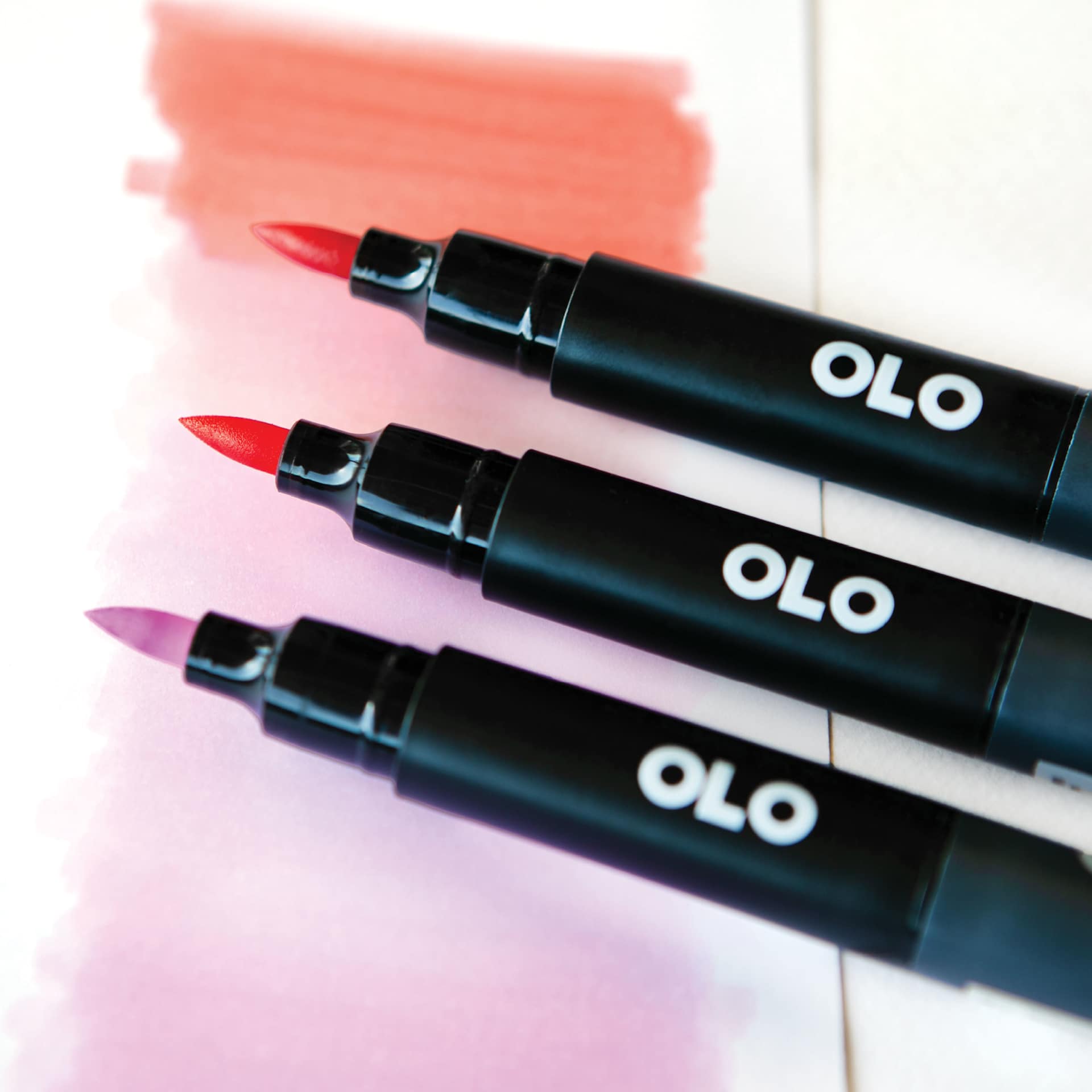 Olo Dual-Tip Markers, close-up of three brush markers laid on paper with blended colors