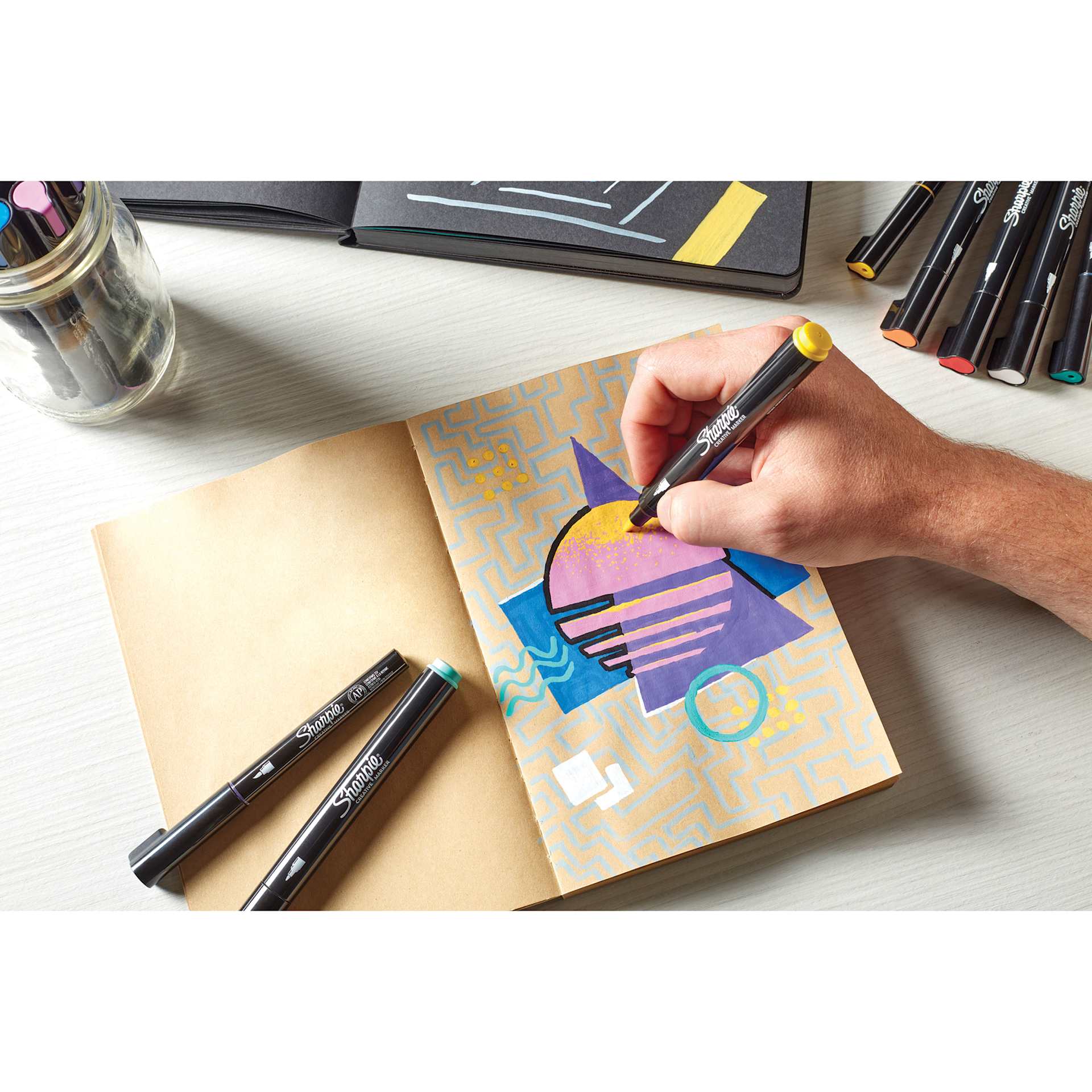 Sharpie Creative Acrylic Markers in hand, layering color on paper Sharpie Creative Acrylic Markers in hand, layering color on paper