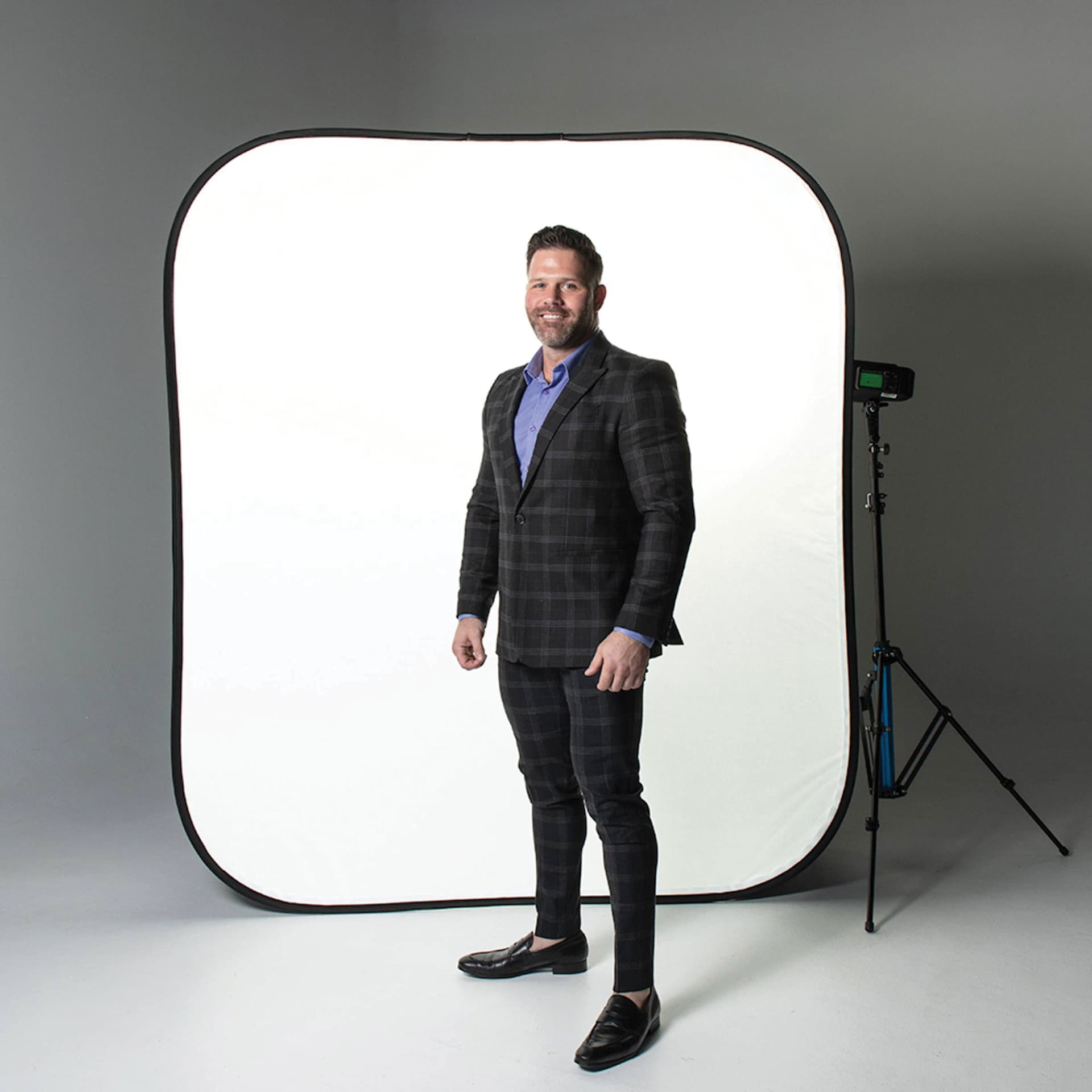 Savage High Key Freestanding Background - 6 ft x 7 ft in use as softbox background behind standing subject