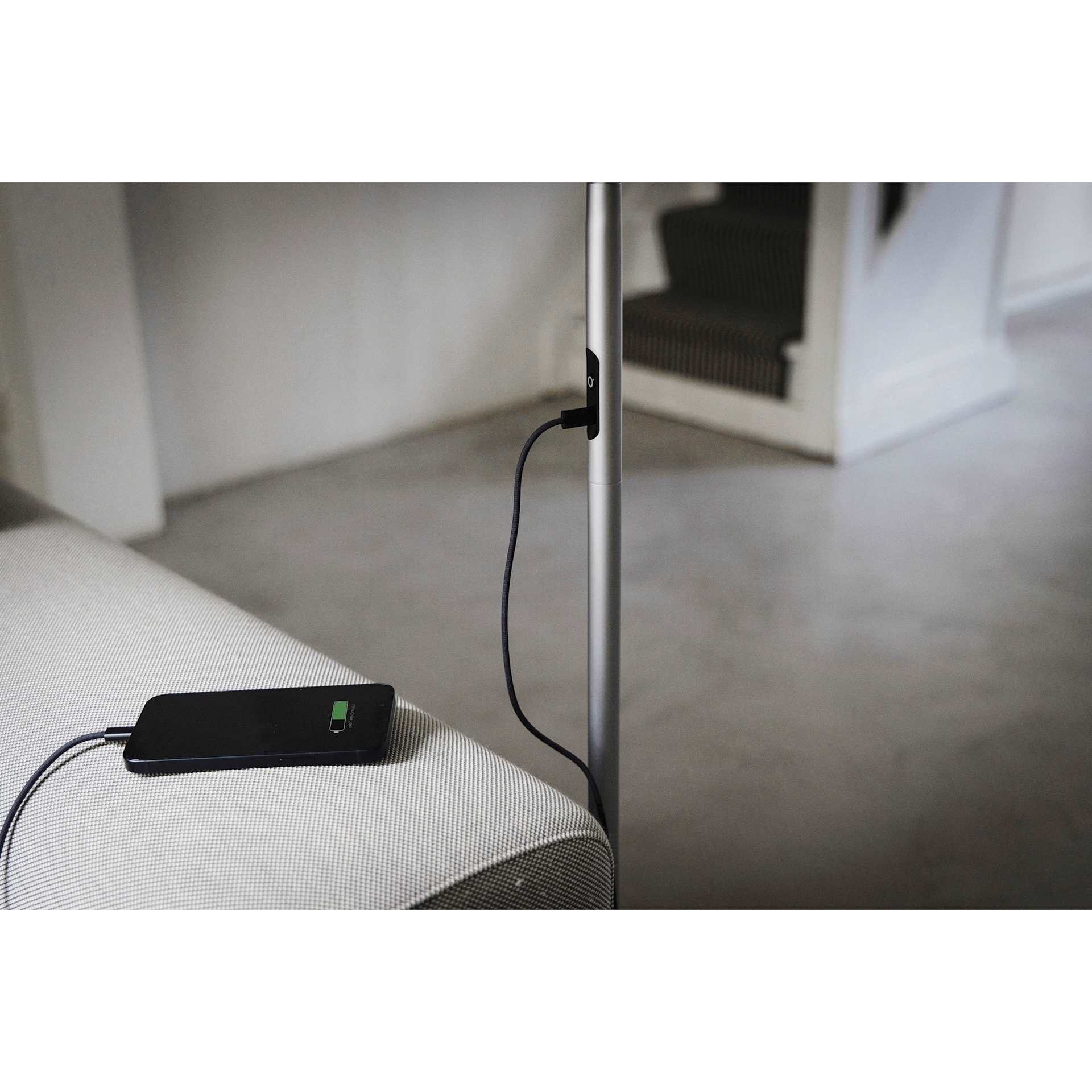 Daylight Slimline 4 LED Floor Lamp - Brushed Steel - demonstrating phone charging capability