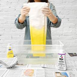 Rit Color Stay Dye Fixative -Woman using fixative on newly dyed pants