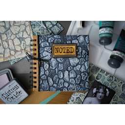 Sizzix 3-D Texture Fades Embossing Folder - Cobblestone applied to cover of notebook
