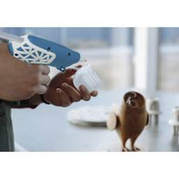 Studio Designs Cordless Glue Gun - Blue and White w/ Web Grip - in use, close-up