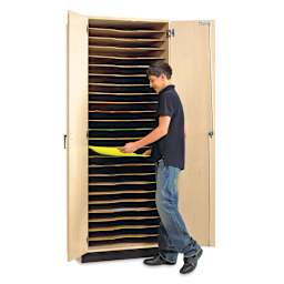Paper/Drawing Board Storage Cabinet - Student at open cabinet removing Art Paper from slot