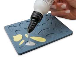 Sculpey Oven Safe Flowers Mold person filling mold with liquid sculpey