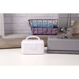 Singer Portable Bobbin Winder, next to a full size sewing machine