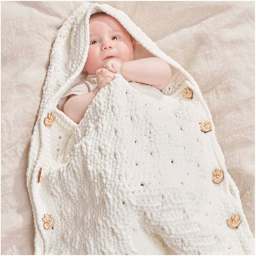 Rico Design Creative Chenillove Yarn - Cream, 120 yds showing completed baby sleep sack project