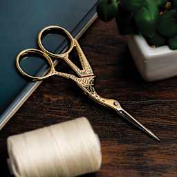 Singer Stork Embroidery Scissors - laying on table