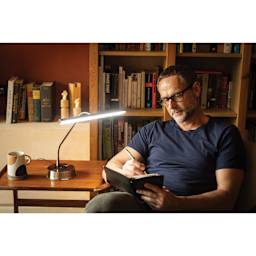 Daylight Libra Table Lamp - person writing in journal